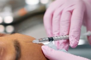 Close Up Photo of Injecting Botox on Forehead